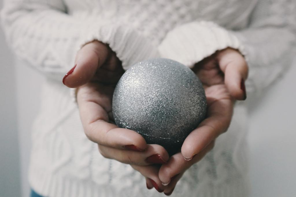 woman's hands holding ball