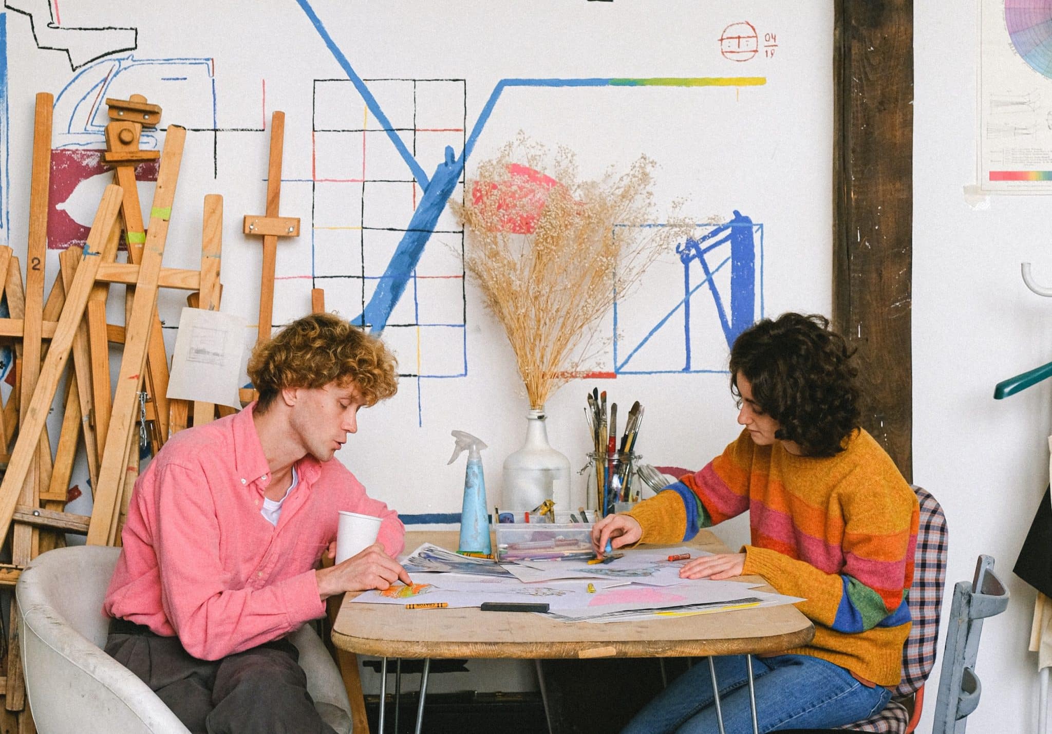 productive pair of artists in studio not using phones