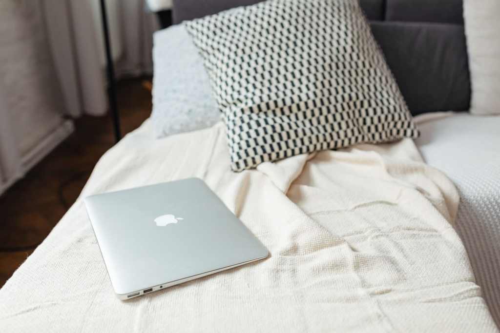 closed laptop on sofa