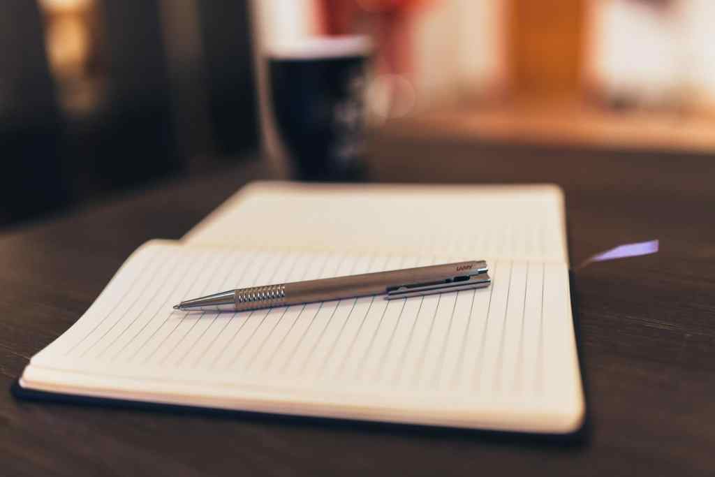 pen and blank notebook with coffee writer morning