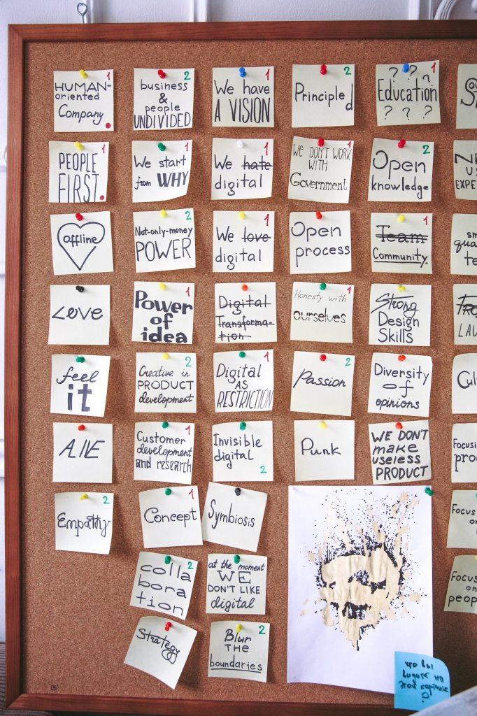 motivational and inspiring post it notes on a pinboard