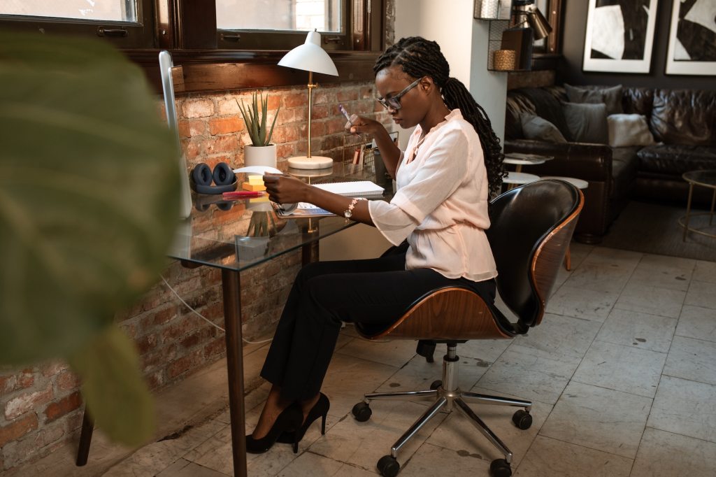 Woman working from minimal home workspace 