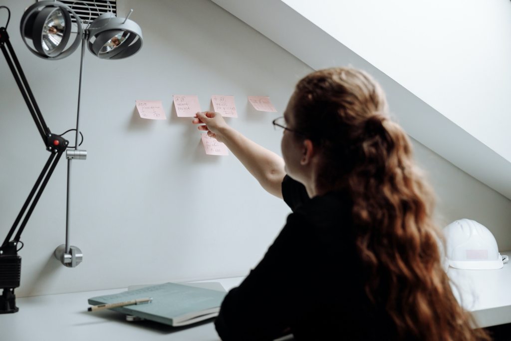 Woman working in home office productive with post-it notes