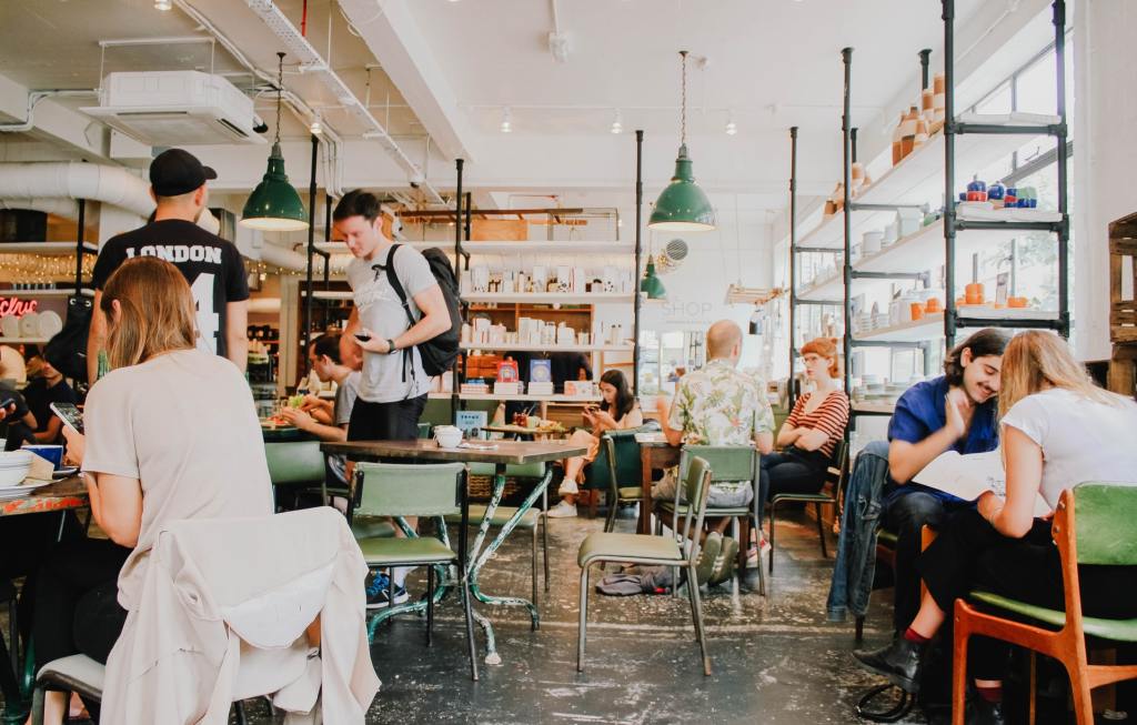 people working in a coffee shop in the morning